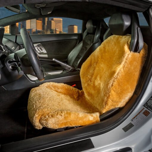 sheepskin seat cover installed in a luxury car. The cover is a light brown color and appears to be made of real sheepskin. It covers the entire seat, including the back and headrest.