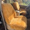 interior of a car with sheepskin seat covers. The covers are a light brown color